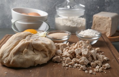 Different types of yeast, eggs, flour and dough on grey table