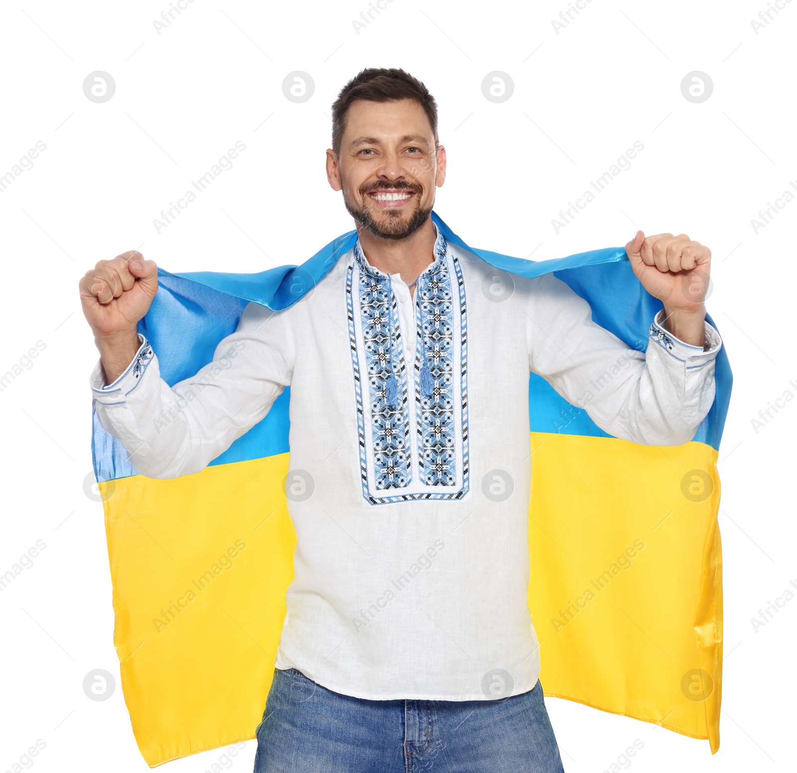 Photo of Happy man in Ukrainian national clothes with flag of Ukraine on white background