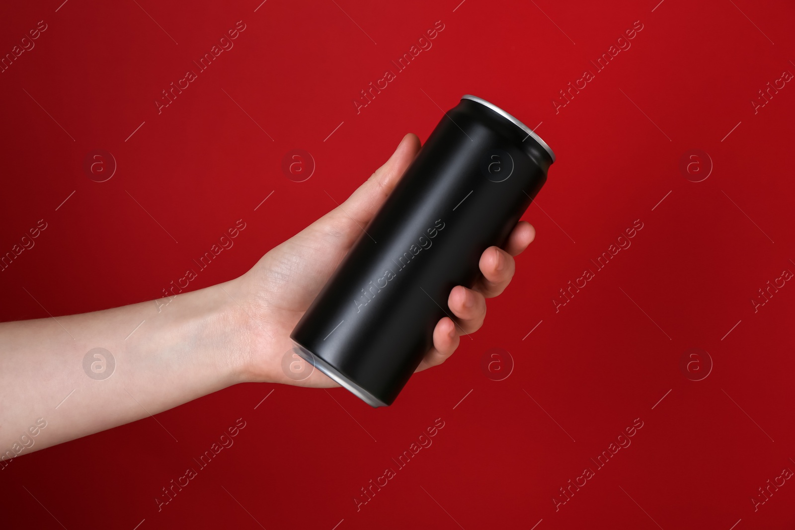 Photo of Woman with energy drink on red background, closeup