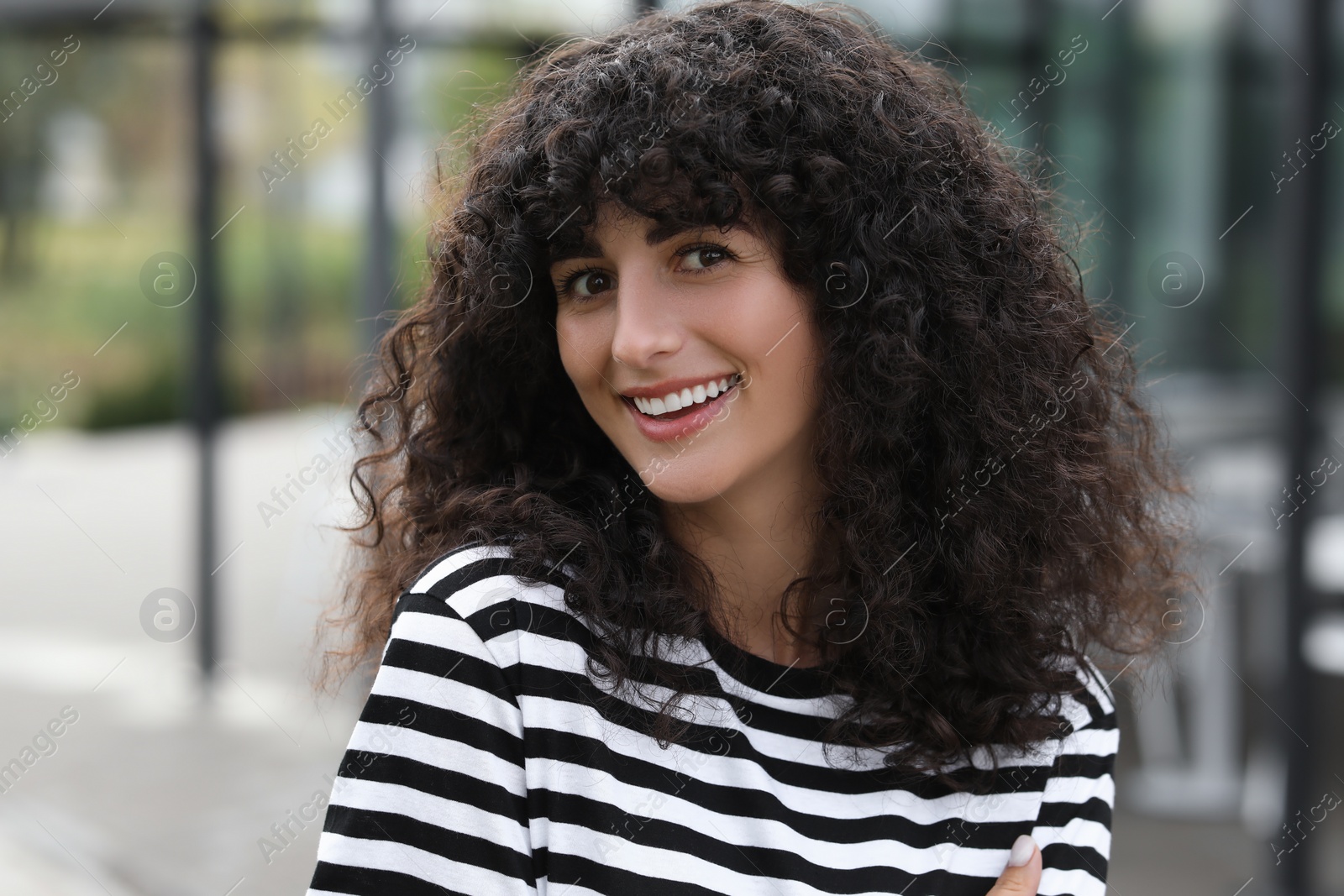 Photo of Portrait of beautiful woman outdoors. Attractive lady smiling and looking into camera