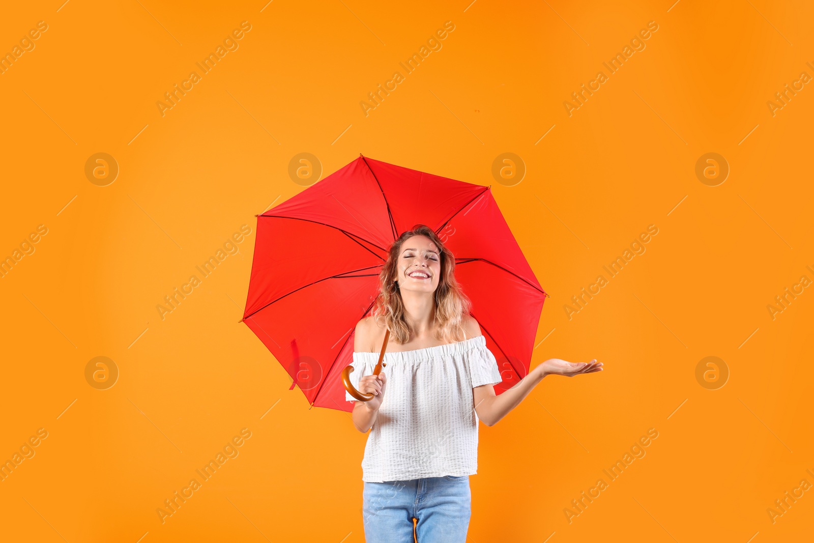 Photo of Woman with red umbrella on color background