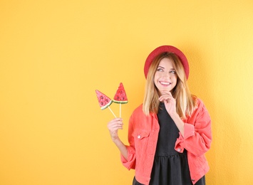Photo of Young pretty woman with candies on colorful background. Space for text