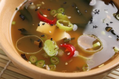 Photo of Bowl of delicious miso soup with tofu, closeup