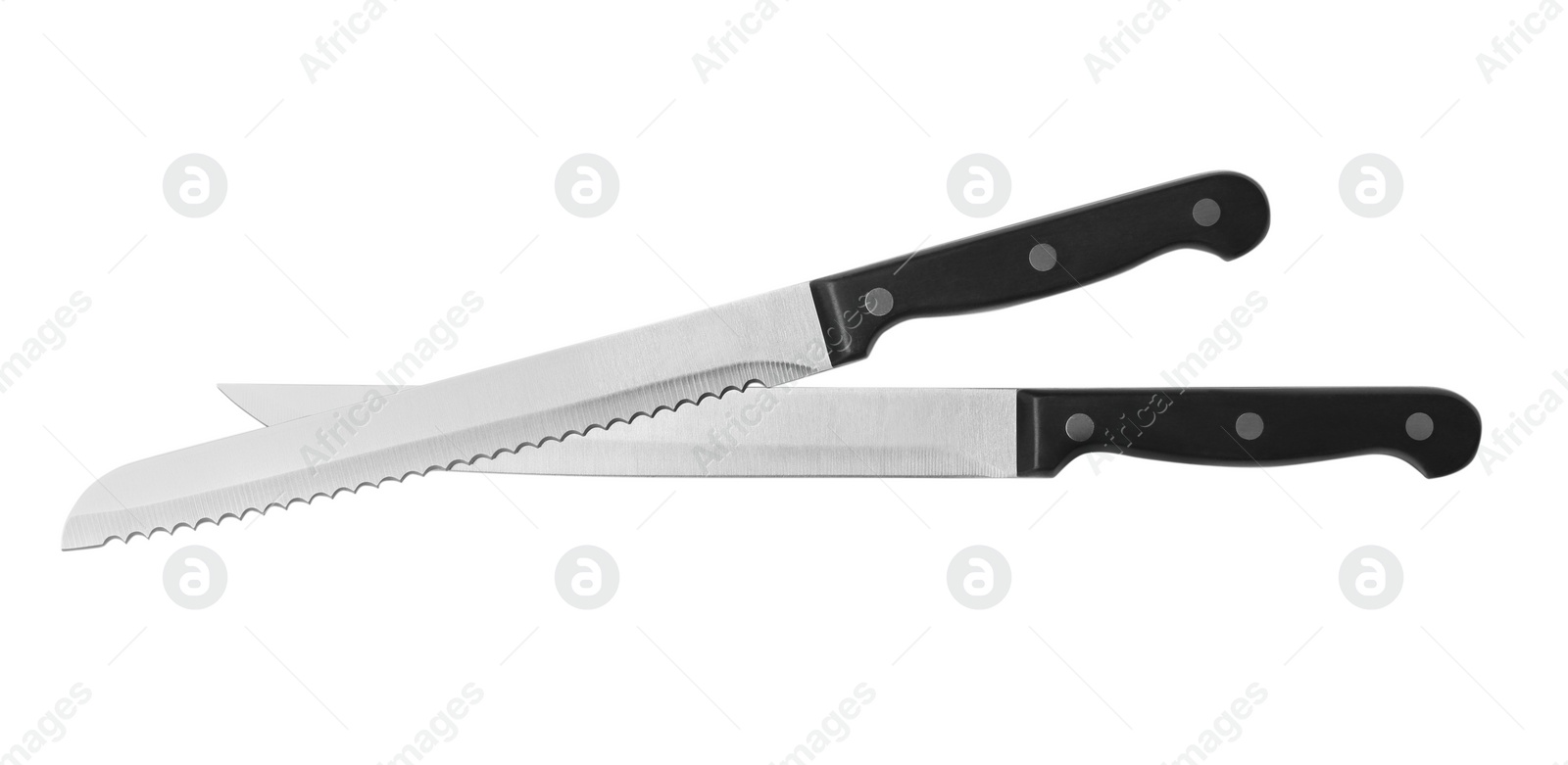 Photo of Stainless steel knives on white background, top view
