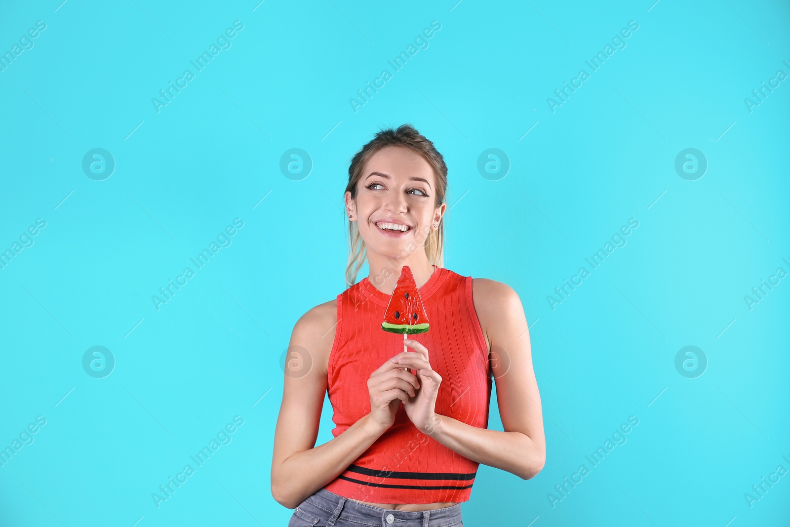 Photo of Young pretty woman with candy on colorful background