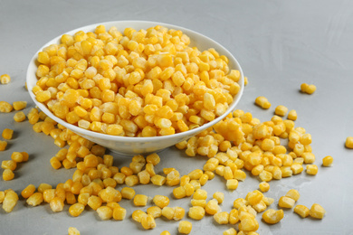 Photo of Frozen corn on light grey table. Vegetable preservation