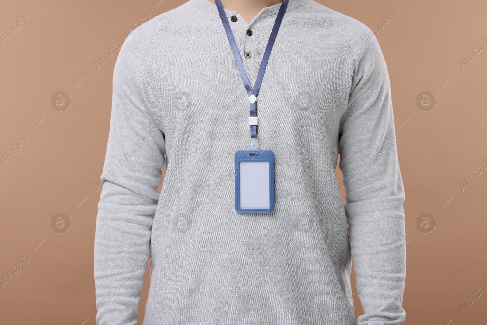 Photo of Man with blank badge on beige background, closeup