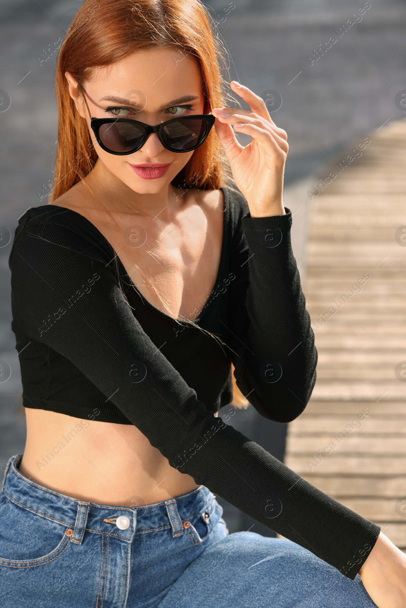 Photo of Beautiful woman in sunglasses outdoors on sunny day,