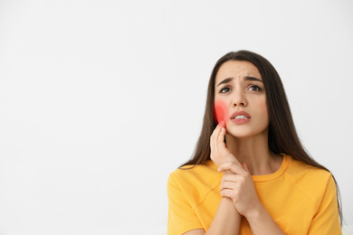 Image of Young woman suffering from toothache on white background