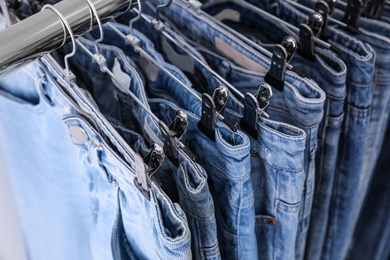 Photo of Closeup view of rack with different jeans