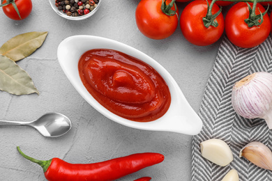 Photo of Flat lay composition with tomato sauce on light grey table