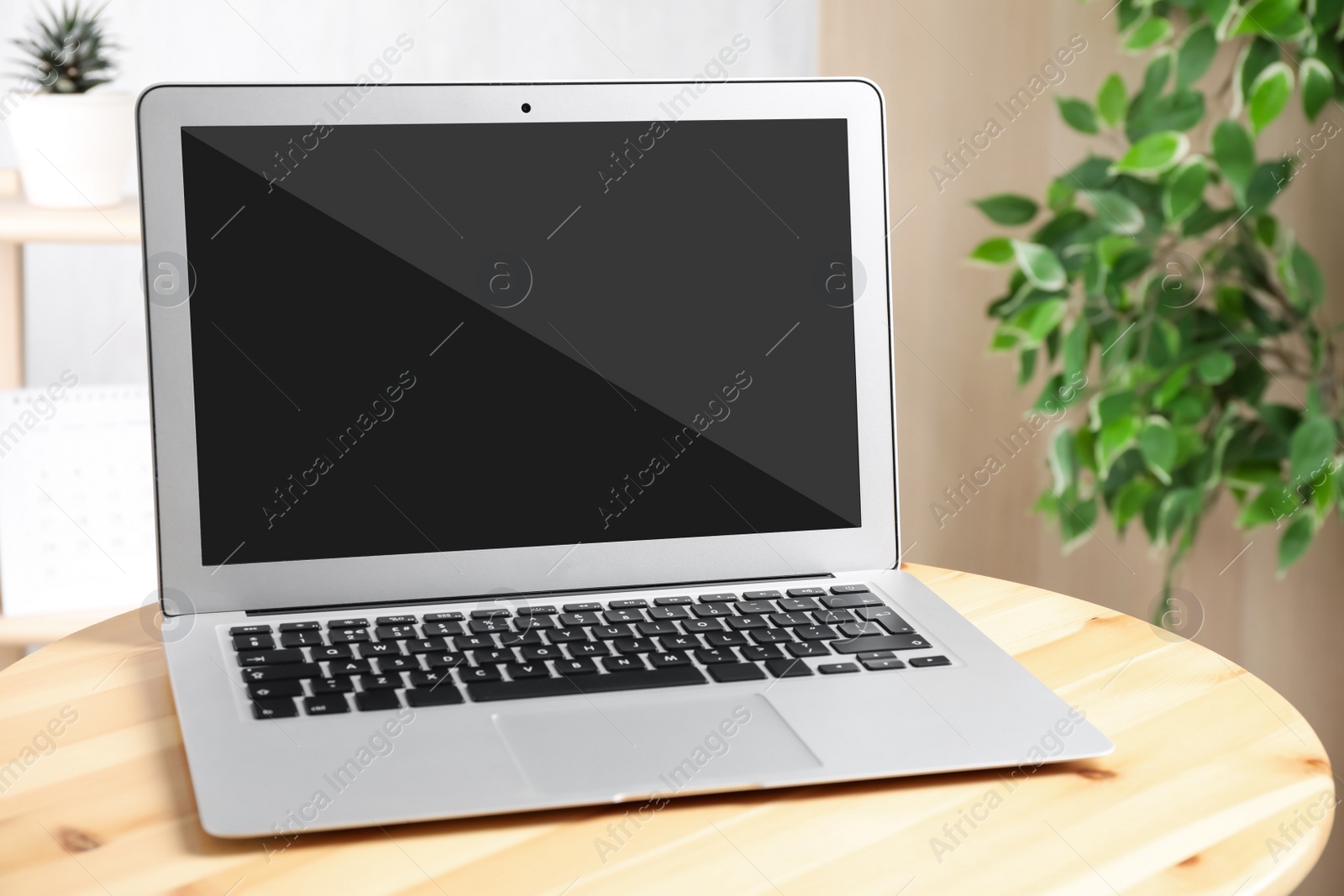 Image of Modern laptop on wooden table indoors. Comfortable workplace 