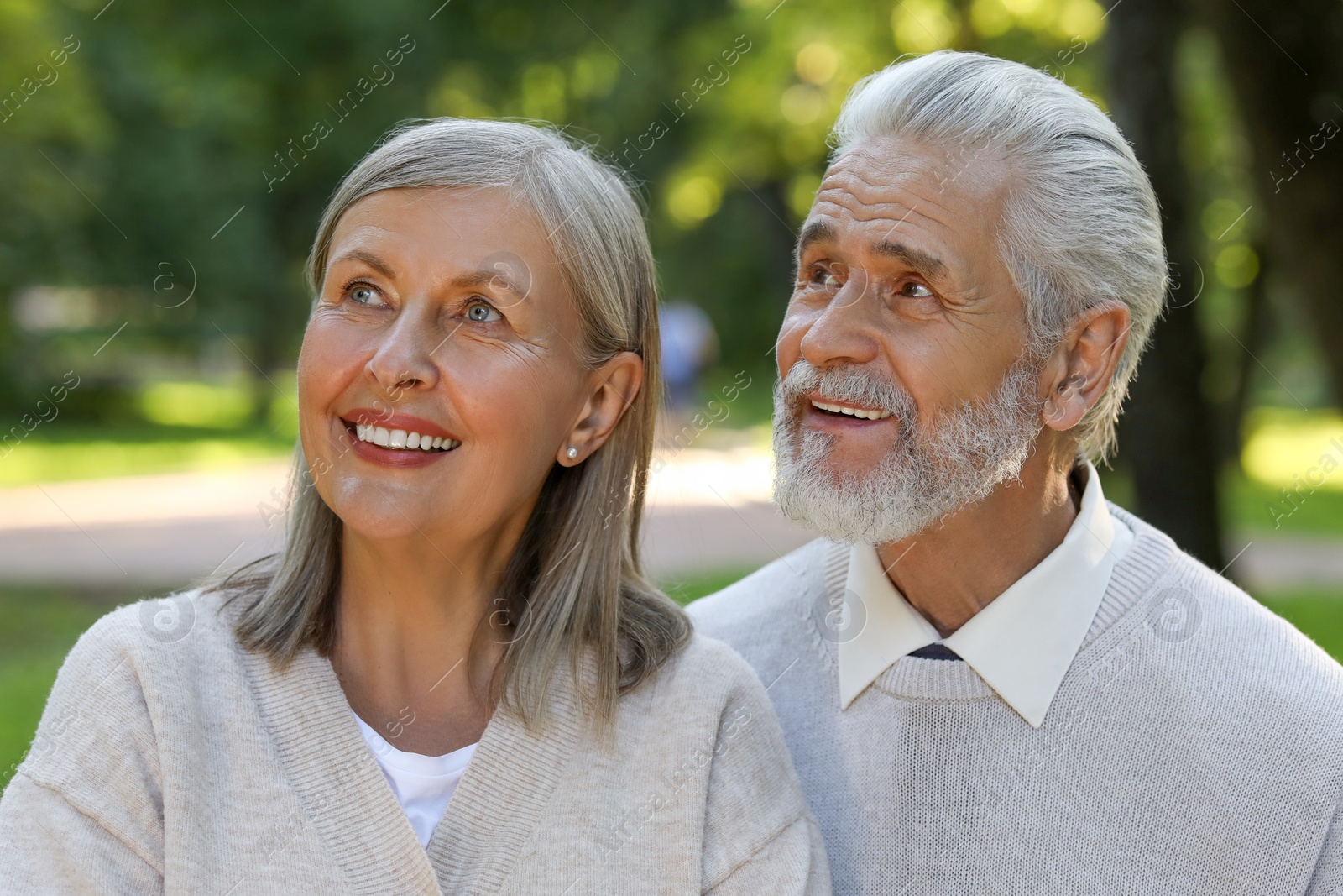 Photo of Affectionate senior couple spending time together in park. Romantic date