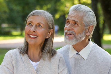 Photo of Affectionate senior couple spending time together in park. Romantic date