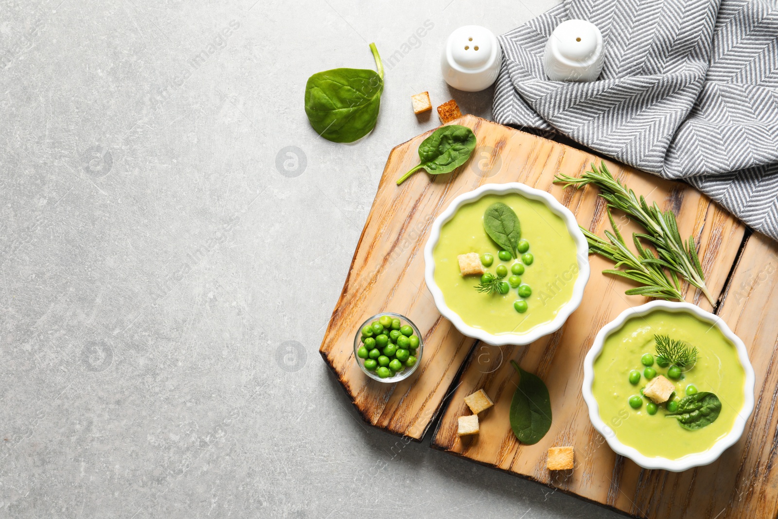 Photo of Fresh vegetable detox soup made of green peas and spinach served on table, top view with space for text