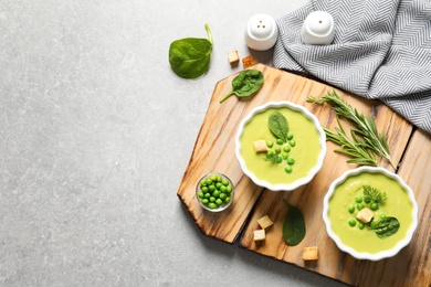 Photo of Fresh vegetable detox soup made of green peas and spinach served on table, top view with space for text