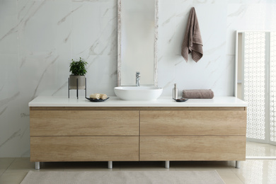 Modern bathroom interior with stylish mirror and vessel sink