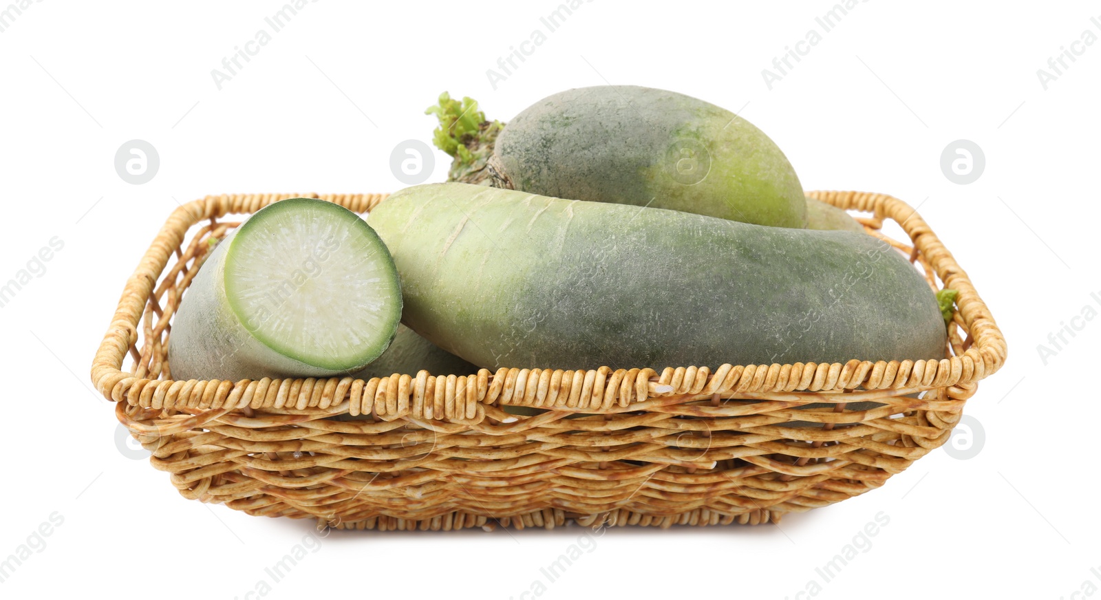 Photo of Green daikon radishes in wicker basket isolated on white