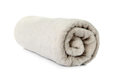 Photo of Rolled clean beige towel on white background