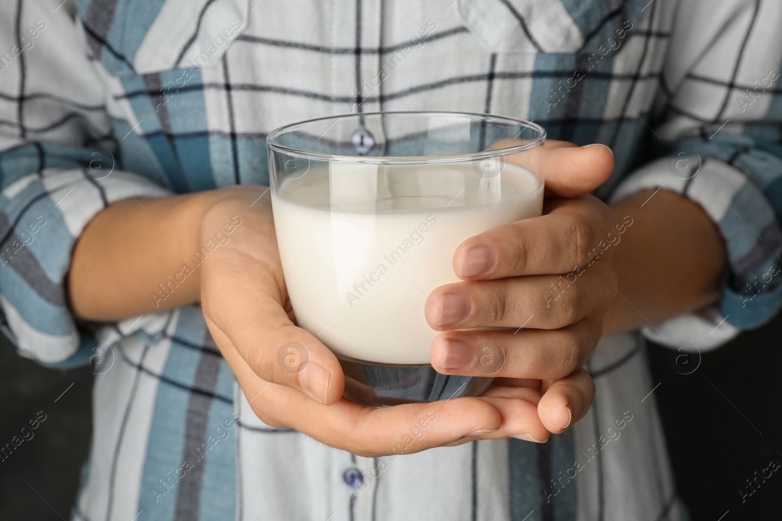 Photo of Woman holding glass of hemp milk, closeup