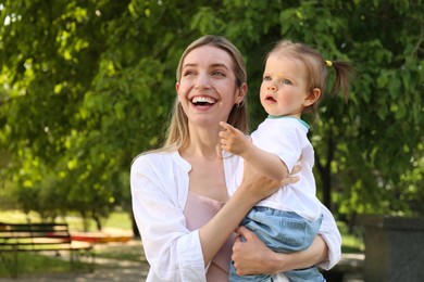 Happy mother with her daughter spending time together in park