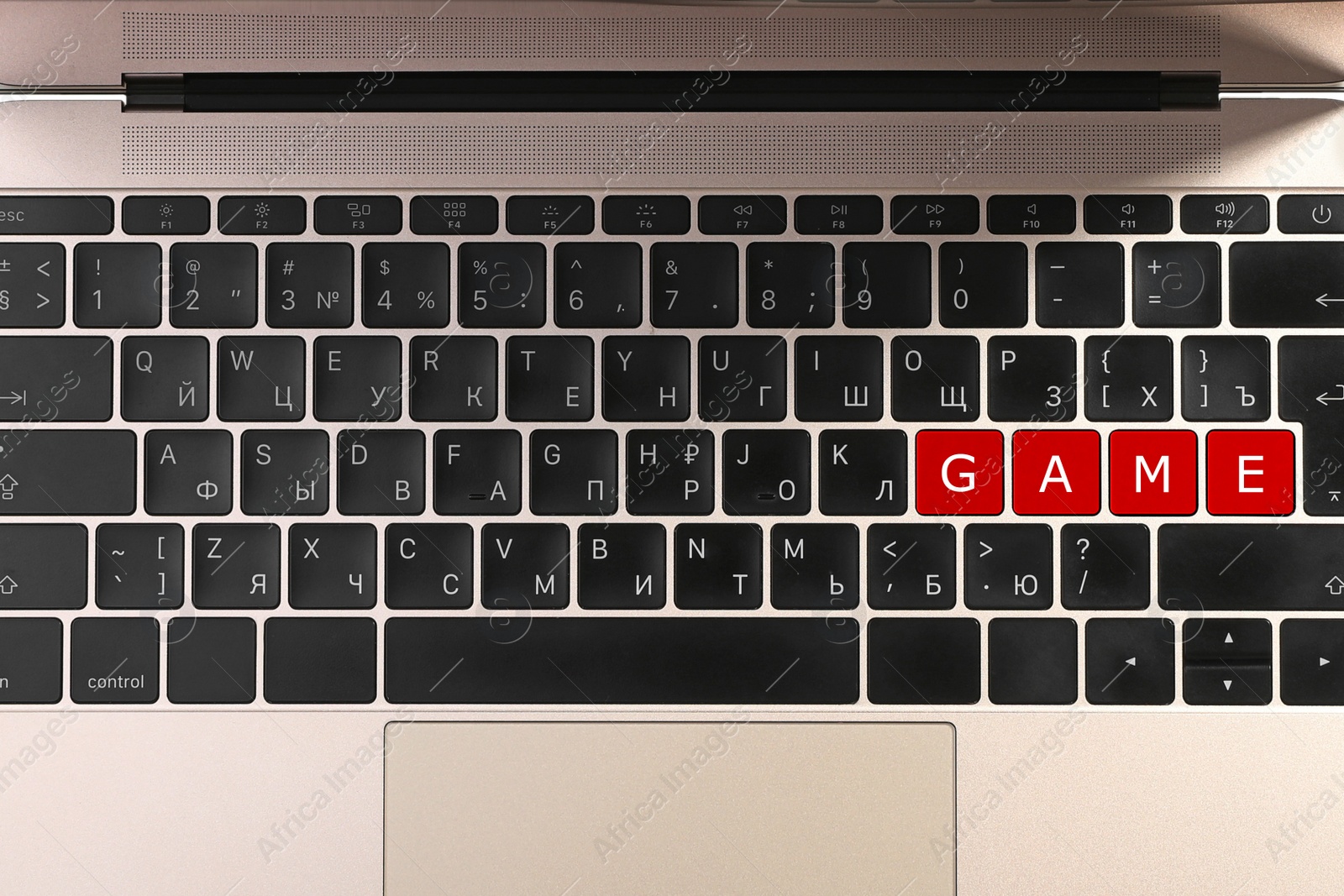 Image of Red buttons with letters G A M E on laptop keyboard, top view