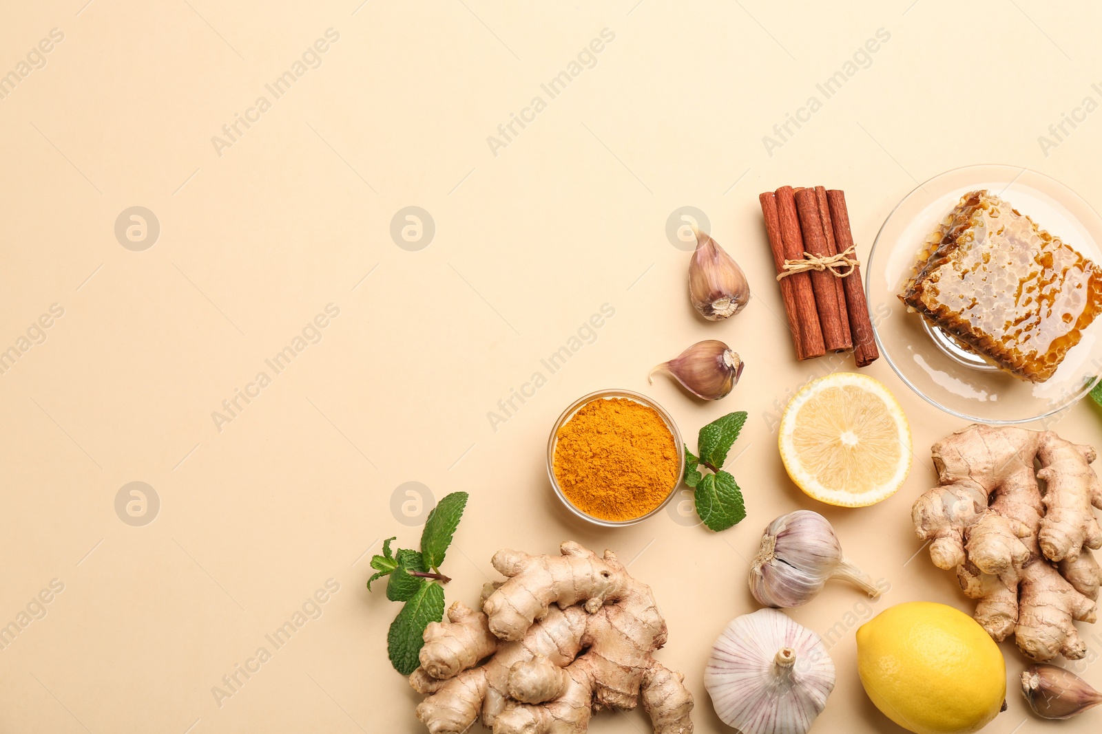 Photo of Flat lay composition with fresh products on beige background, space for text. Natural antibiotics