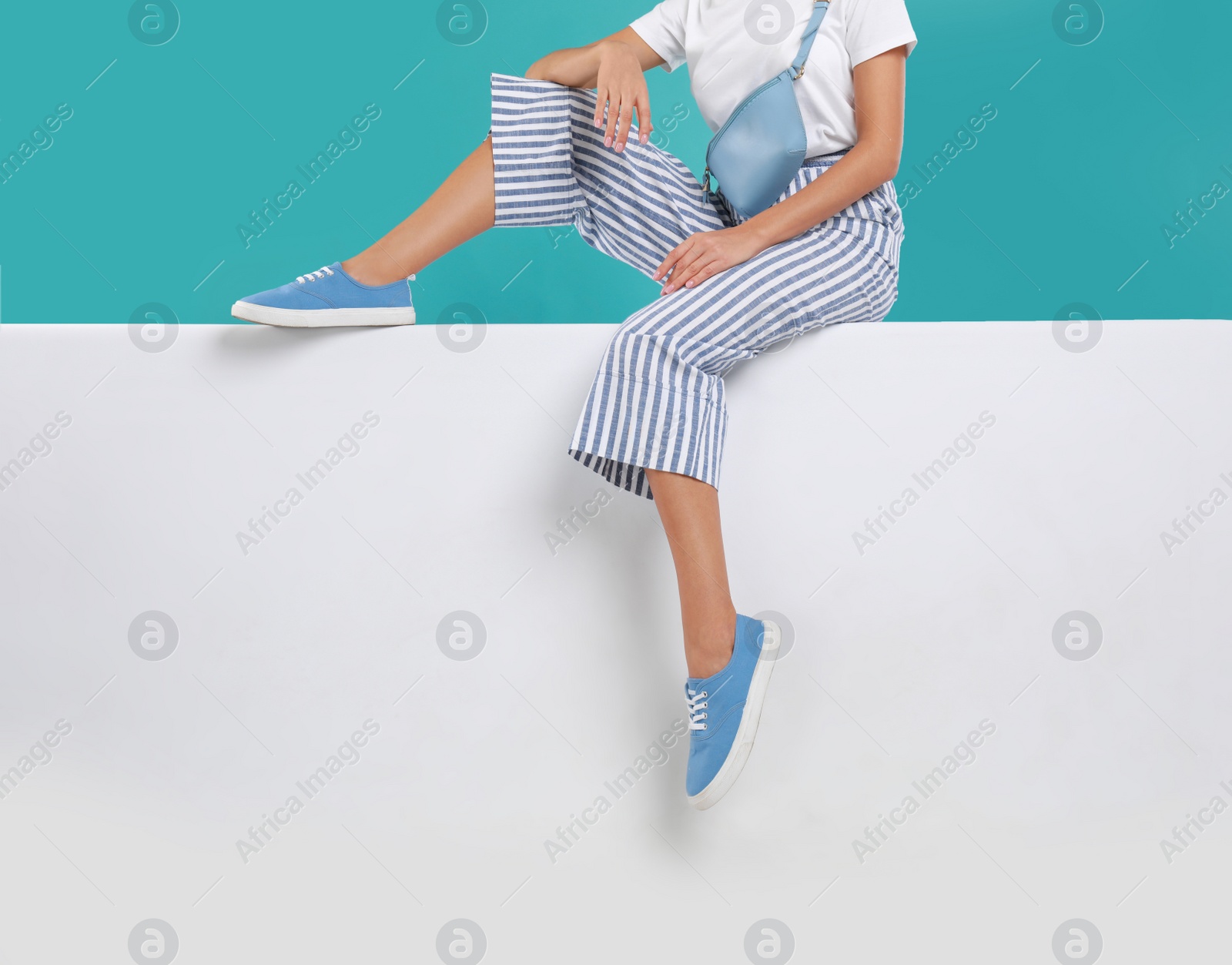 Photo of Woman wearing stylish shoes on color background, closeup