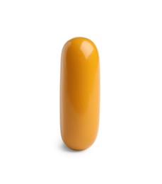 Photo of One orange pill on white background. Medicinal treatment