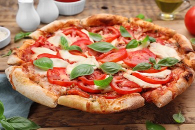 Photo of Delicious Caprese pizza on wooden table, closeup