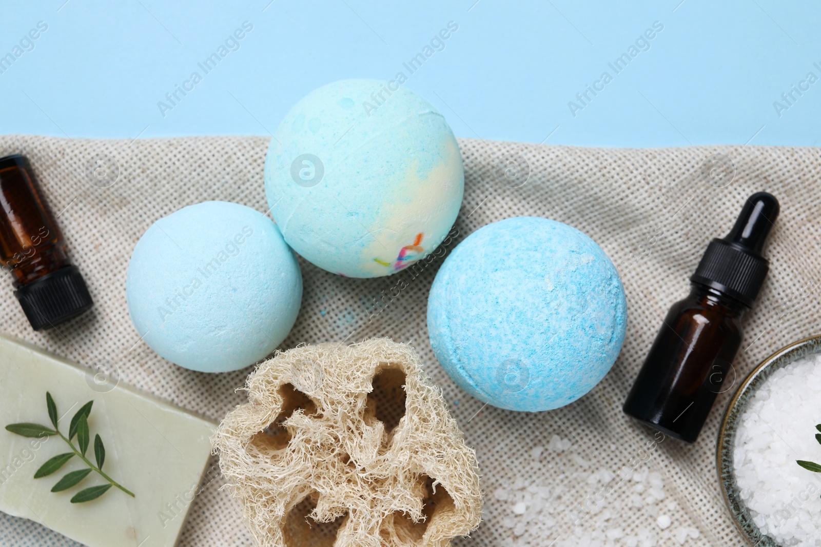 Photo of Flat lay composition with bath bombs on light blue background