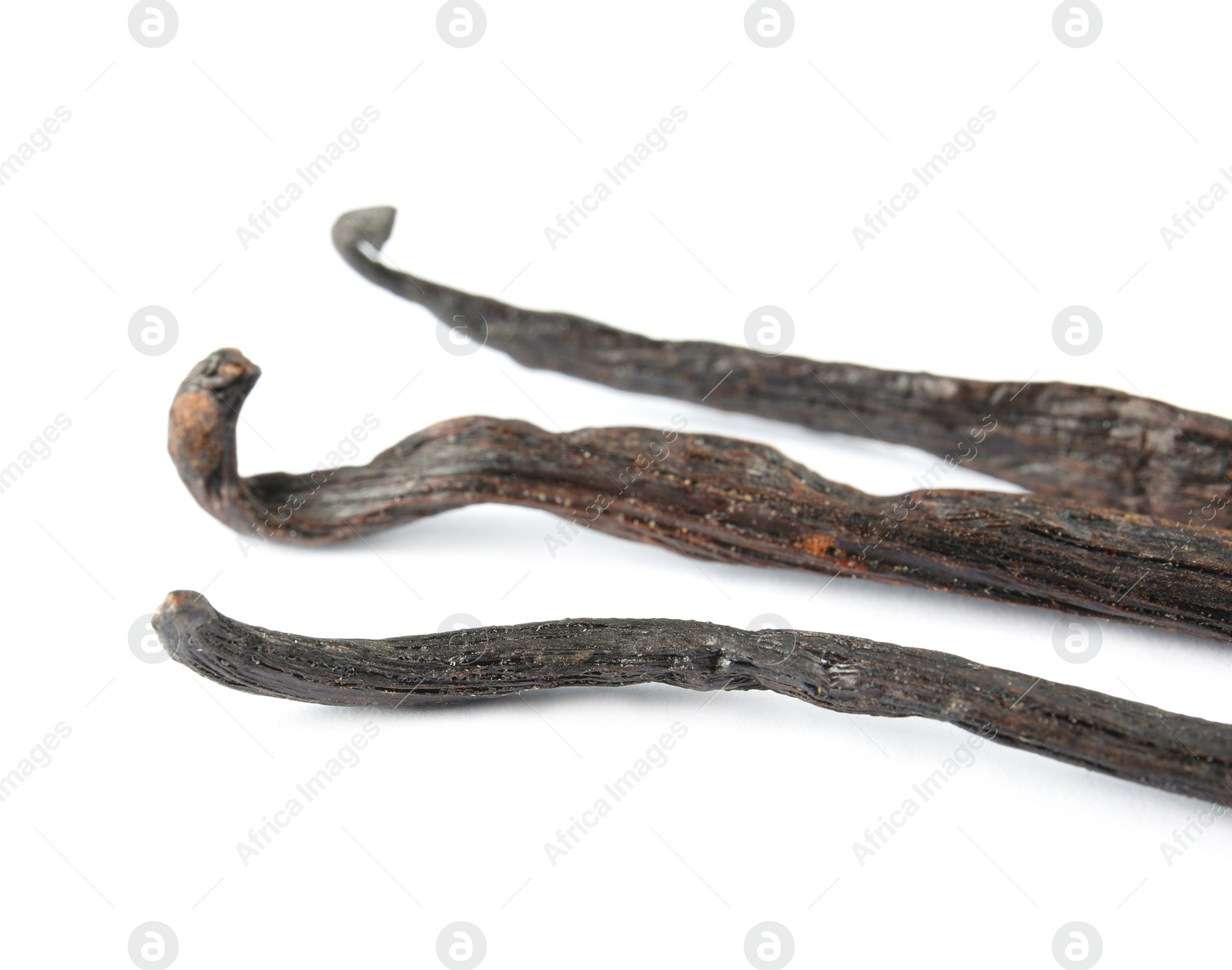 Photo of Dried aromatic vanilla sticks on white background, closeup