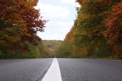 Beautiful view of asphalt highway going through autumn forest