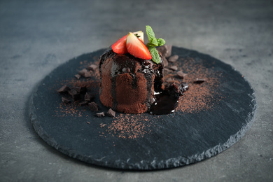 Photo of Delicious warm chocolate lava cake on grey table
