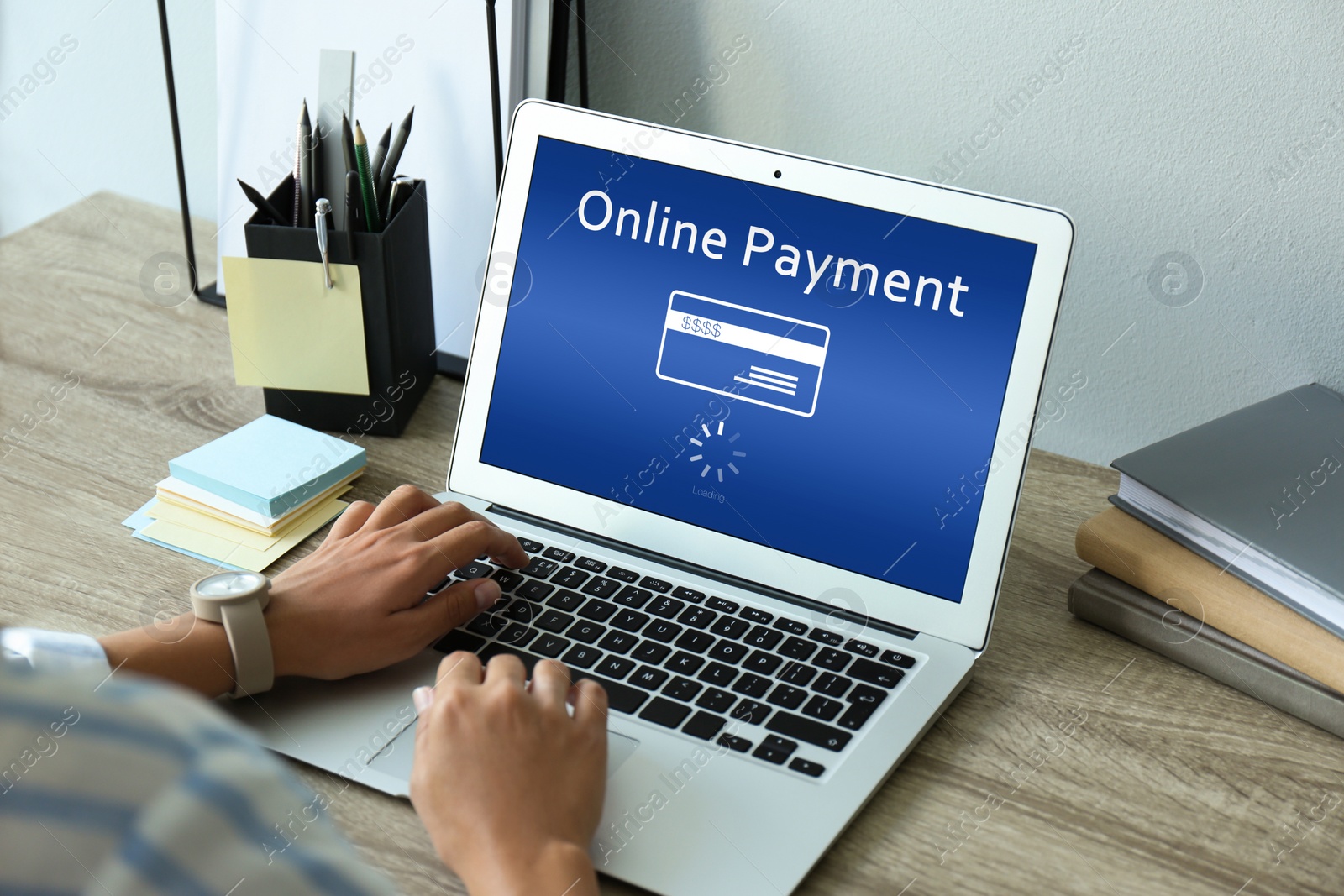 Image of Woman using laptop for online payment at table, closeup