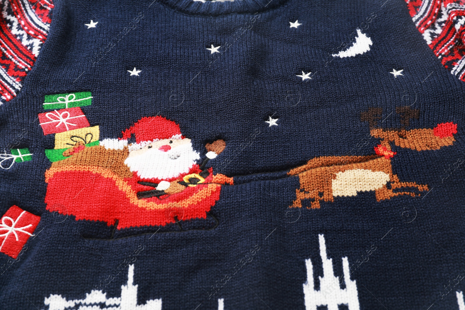 Photo of Cute Christmas sweater as background, closeup view