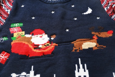 Photo of Cute Christmas sweater as background, closeup view