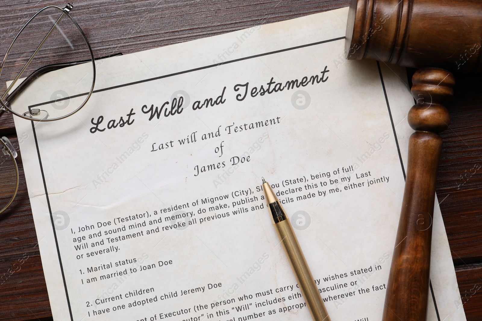 Photo of Last Will and Testament with glasses, gavel and pen on wooden table, flat lay