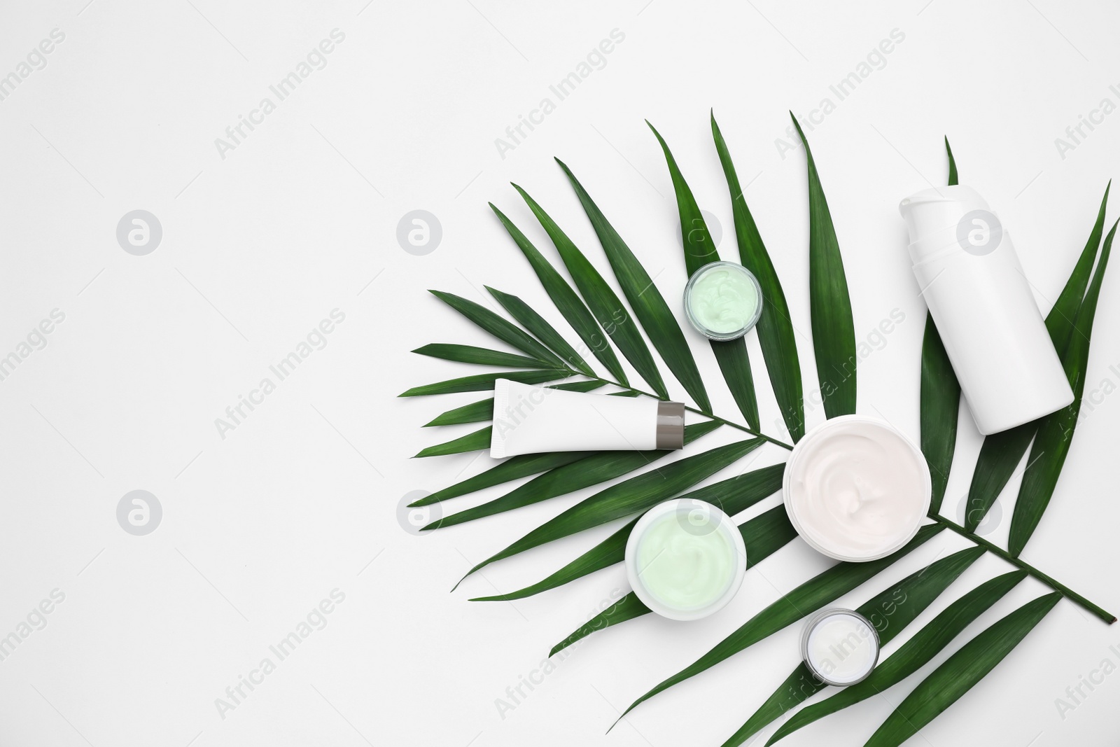 Photo of Flat lay composition with cosmetic products on light background