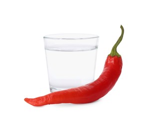 Photo of Red hot chili pepper and vodka in shot glass on white background