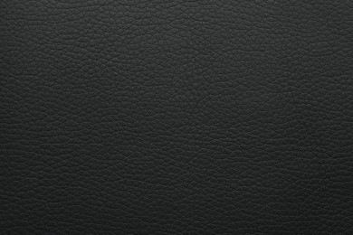 Photo of Texture of black leather as background, closeup