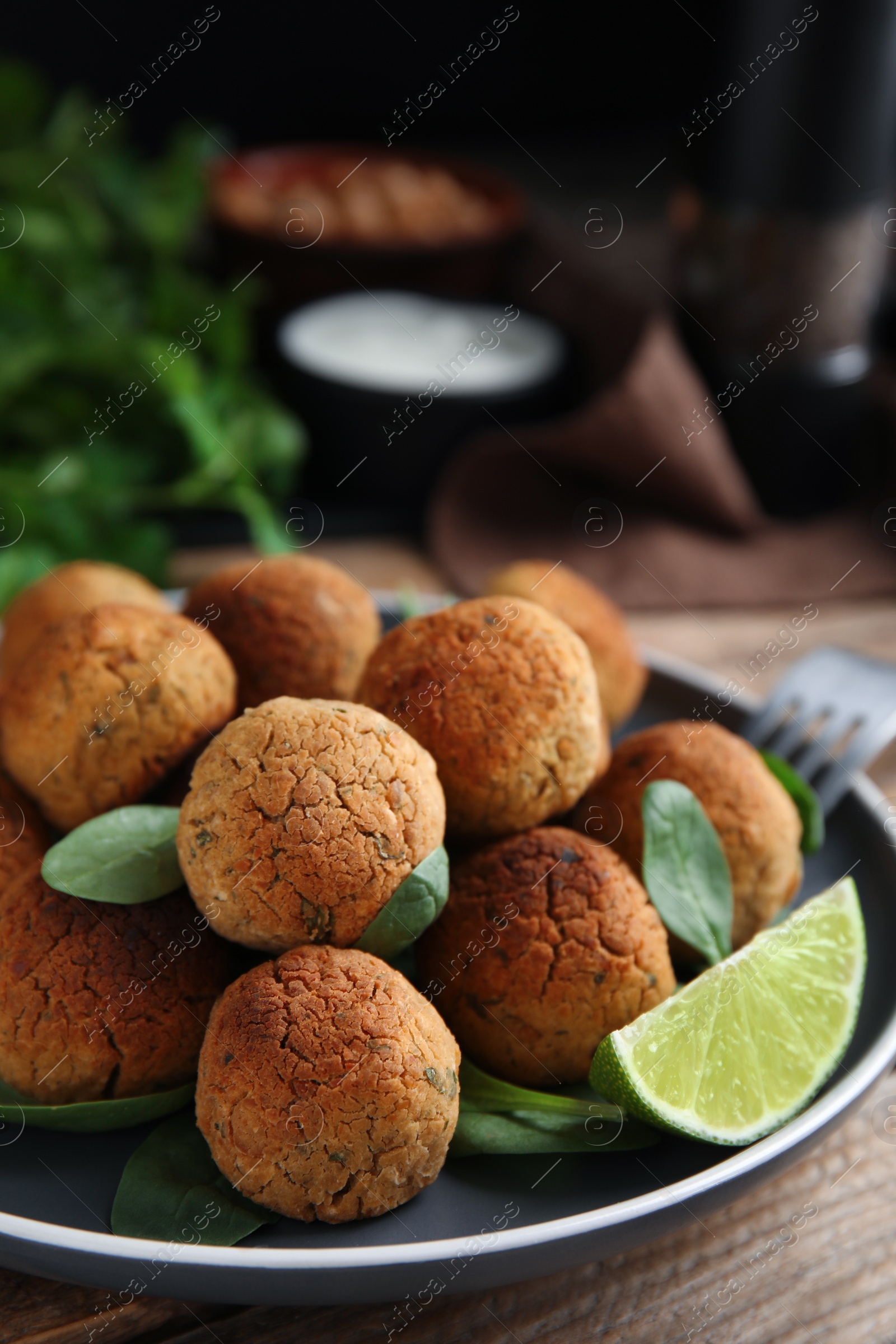 Photo of Delicious falafel balls with lime on table, closeup