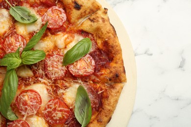 Photo of Delicious Margherita pizza on white marble table, top view