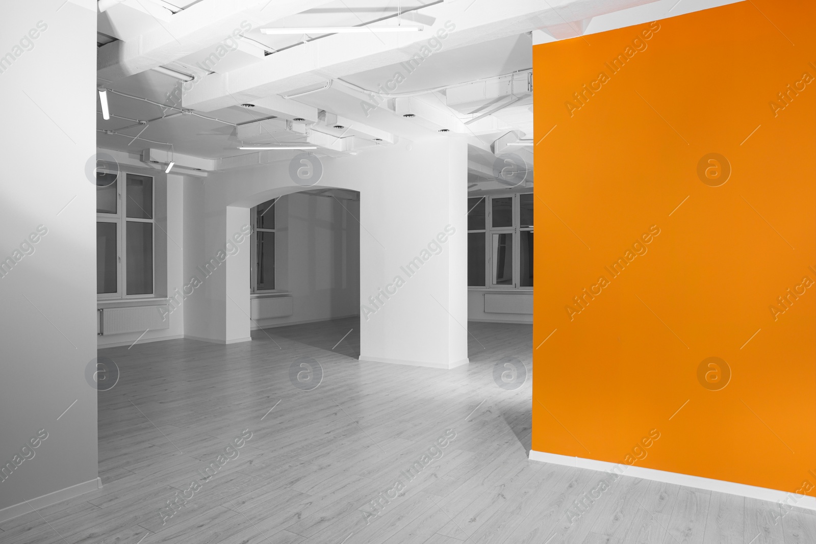 Photo of Empty renovated room with white and orange walls