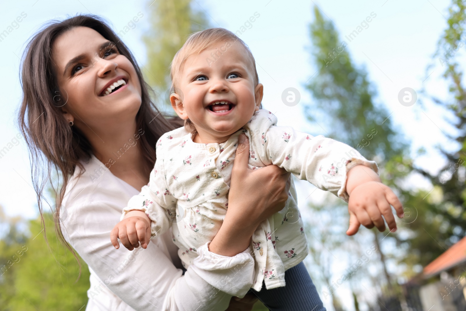 Photo of Happy mother with her cute baby in park on sunny day