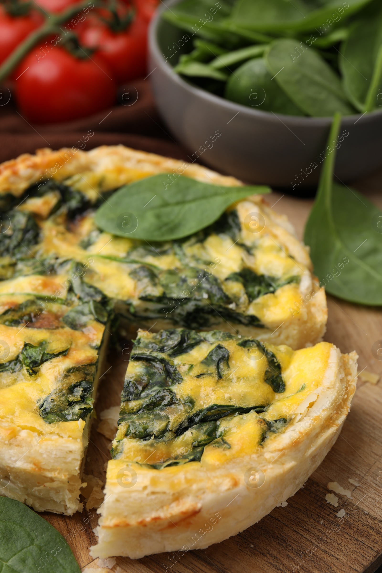 Photo of Delicious pie with spinach on table, closeup