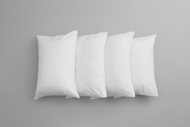 Photo of Clean soft bed pillows on grey background, top view