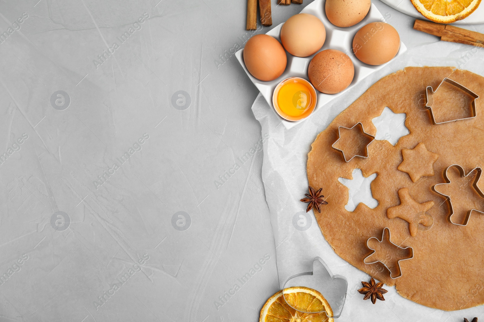 Photo of Flat lay composition with dough and cookie cutters on light table, space for text