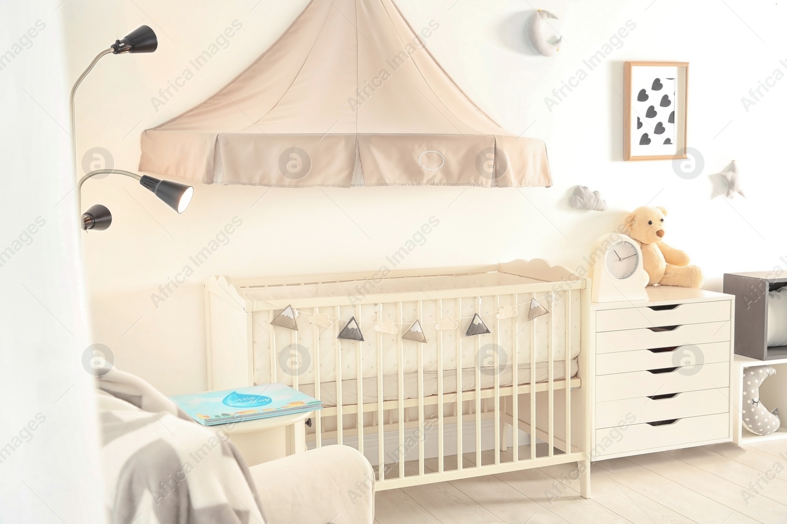 Photo of Stylish baby room interior with crib