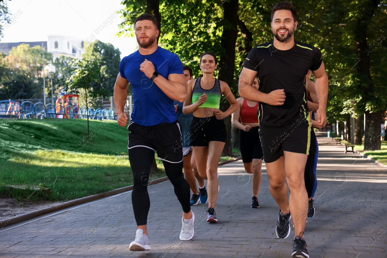 Photo of Group of people running in park. Active lifestyle